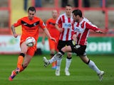 Scunthorpe's Michael Collins and Exeter's Matt Oakley in action during the League Two match on April 26, 2014