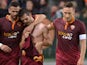 Roma's Miralem Pjanic celebrates with teammates after scoring the opening goal against AC Milan during the Serie A match on April 25, 2014