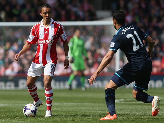 Tottenham's Nacer Chadli and Stoke's Peter Odemwingie in action during their Premier League match on April 26, 2014