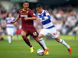 Ravel Morrison of Queens Park Rangers is challenged by Mathias Ranegie of Watford during the Sky Bet Championship match between Queens Park Rangers and Watford at Loftus Road on April 21, 2014