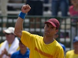 Colombian tennis player Santiago Giraldo celebrates after defeating Dominican Jose Hernandez during their Davis Cup Americas Group I second round singles tennis match at the 'Alvaro Carlos Jordan' tennis stadium in Cali, Colombia, on April 4, 2014