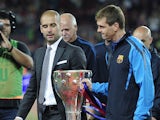 Barcelona's coach Josep Guardiola and second coach Tito Vilanova hold the Spanish league trophy as they celebrate their team's victory in the Spanish League after their Spanish league football match against RC Deportivo de la Coruna at the Camp Nou stadiu