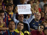 A Barcelona's supporter holds a messae in honour of former coach Tito Vilanova at the end of the Spanish Super Cup second leg football match FC Barcelona vs Atletico Madrid at the Camp Nou stadium in Barcelona on August 28, 2013