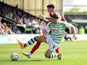 Joe Edwards of Yeovil Town battles for the ball with Adam Hammill of Huddersfield Town during the Sky Bet Championship match between Yeovil Town and Huddersfield Town at Huish Park on April 21, 2014