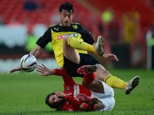 Albert Riera of Watford battles with Diego Poyet of Charlton during the Sky Bet Championship match between Charlton Athletic and Watford at The Valley on April 29, 2014