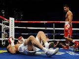 WBA super lightweight champion Amir Khan of England (R) looks at Marcos Maidana of Argentina on December 11, 201