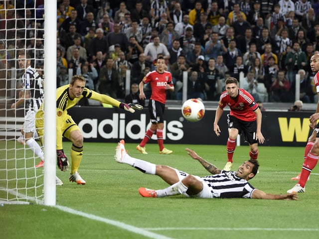 Benfica's Slovenian goalkeeper Jan Oblak and teammates eye the ball as Juventus' Argentinian foward Carlos Tevez tries to score during the UEFA Europa League semifinal football match Juventus vs Benfica on May 1st, 2014