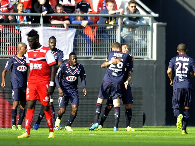 Bordeaux's French defender Julien Faubert celebrates with teammates after scoring a goal during the French L1 football match between Valenciennes and Bordeaux at the Stade du Hainaut in Valenciennes on May 4, 2014