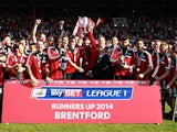 Brentford players and staff celebrates with the trophy as League One runner-ups after their final League One match on May 3, 2014