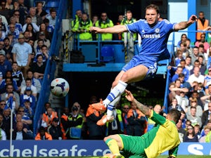 Chelsea's Serbian defender Branislav Ivanovic defends a shot on goal from Norwich City's English midfielder Bradley Johnson (bottom) during the English Premier League football match between Chelsea and Norwich City at Stamford Bridge in London on May 4, 2