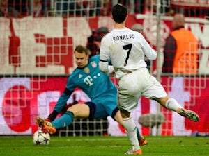 Real Madrid's Portuguese forward Cristiano Ronaldo (R) scores the 0-3 past Bayern Munich's goalkeeper Manuel Neuer during the UEFA Champions League second-leg semi-final football match on April 29, 2014