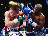 Floyd Mayweather Jr. throws a right to Canelo Alvarez during their WBC/WBA 154-pound title fight at the MGM Grand Garden Arena on September 14, 2013