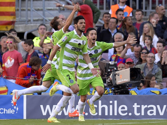 Getafe's players celebrate after scoring a goal during the Spanish league football match FC Barcelona vs Getafe CF at the Camp Nou stadium in Barcelona on May 3, 2014