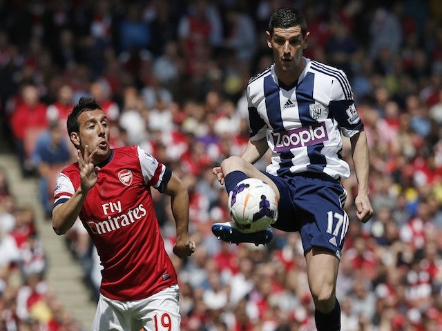 West Bromwich Albion's Graham Dorrans (R) controls the ball as Arsenal's Santi Cazorla (L) chases during the English Premier League football match on May 4, 2014