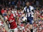 West Bromwich Albion's Graham Dorrans (R) controls the ball as Arsenal's Santi Cazorla (L) chases during the English Premier League football match on May 4, 2014