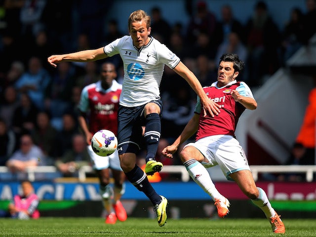 Harry Kane of Spurs is challenged by James Tomkins of West Ham during the Barclays Premier League match on May 3, 2014