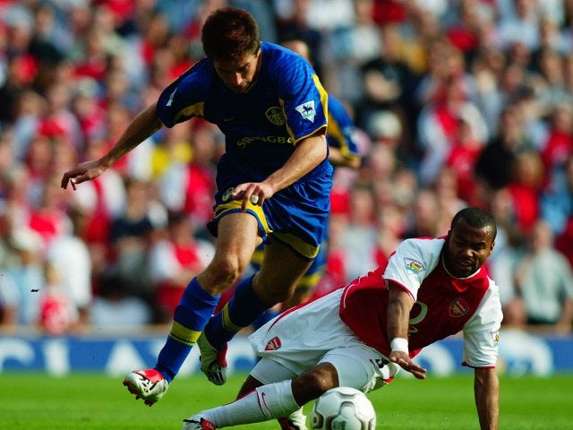 Harry Kewell, then of Leeds United, skips away from Arsenal full-back Ashley Cole on May 04, 2003.