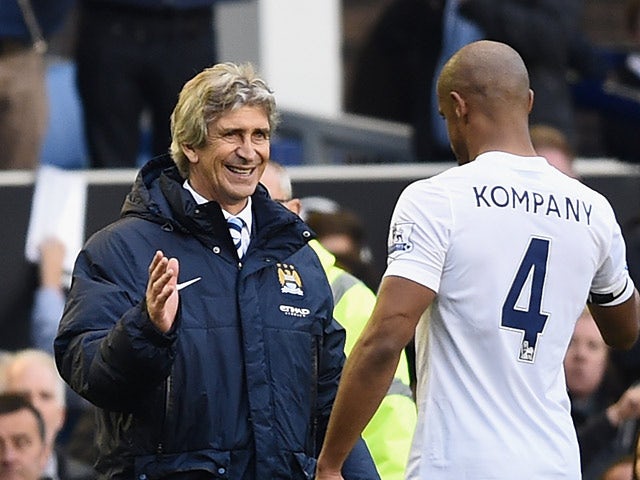 Manchester City manager Manuel Pellegrini congratulates Vincent Kompany at the end of the Premier League match against Everton on May 3, 2014