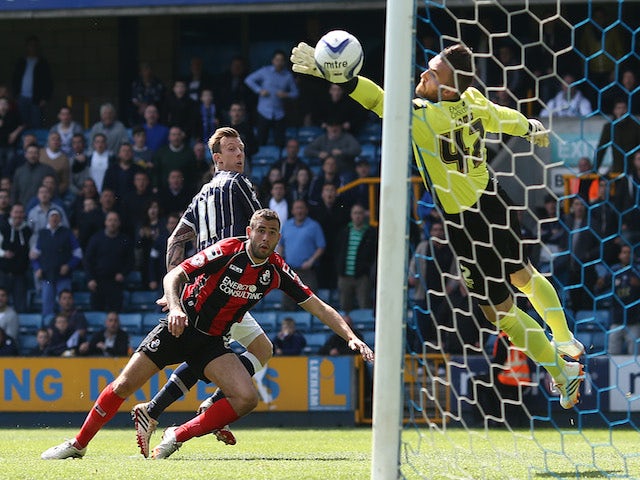 Martyn Woolford of Millwall beats Steve Cook of Bournemouth to the ball to score their first goal of the game during the Sky Bet Championship match on May 3, 2014