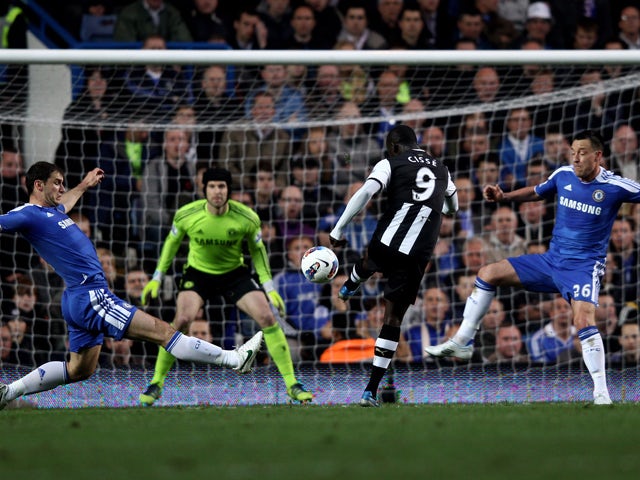 Papiss Cisse of Newcastle scores the opening goal despite the efforts from Branislav Ivanovic (L) and John Terry of Chelsea during the Barclays Premier League match between Chelsea and Newcastle United at Stamford Bridge on May 2, 2012