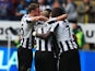Shola Ameobi of Newcastle United is congratulated by team mates as he scores their first goal with a header during the Barclays Premier League match between Newcastle United and Cardiff City at St James' Park on May 3, 2014