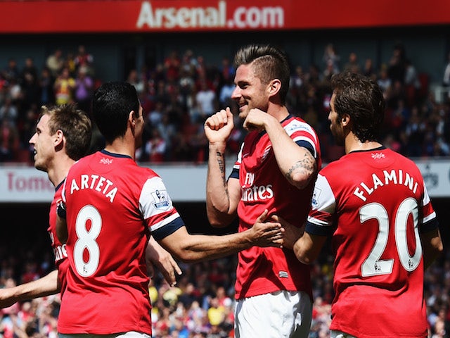 Olivier Giroud (C) of Arsenal celebrates with team mates after scoring during the Barclays Premier League match against West Bromwich Albion on May 4, 2014