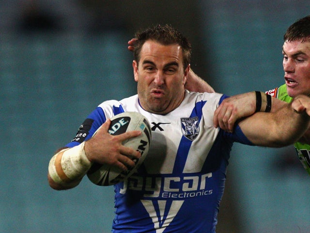 Ryan Tandy of the Bulldogs is tackled byJoe Picker of the Raiders celebrate a try during the round 23 NRL match between the Canterbury Bulldogs and the Canberra Raiders at ANZ Stadium on August 14, 2010 