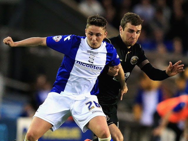 Scott Allan of Birmingham City and James McArthur of Wigan Athletic challenge for the ball during the Sky Bet Championship match on April 29, 2014