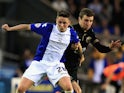 Scott Allan of Birmingham City and James McArthur of Wigan Athletic challenge for the ball during the Sky Bet Championship match on April 29, 2014