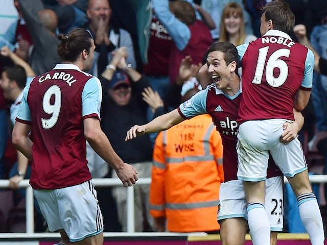 West Ham United's English midfielder Stewart Downing (2nd R) celebrates scoring his team's second goal during the English Premier League football match against Spurs on May 3, 2014