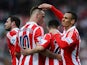 Peter Odemwingie (R) of Stoke City celebrates with team mates after scoring during the Barclays Premier League match between Stoke City and Fulham at the Britannia Stadium on May 3, 2014 