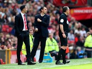 Gustavo Poyet the Sunderland manager celebrates as his team take a 1-0 lead during the Barclays Premier League match between Manchester United and Sunderland at Old Trafford on May 3, 2014 