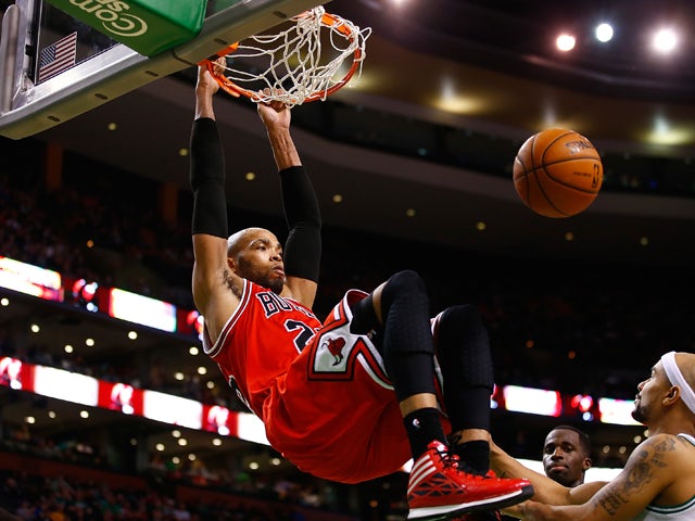 Taj Gibson #22 of the Chicago Bulls dunks the ball against the Boston Celtics in the second half during the game at TD Garden on March 30, 2014
