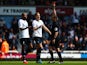 Referee Phil Dowd shows the red card to Younes Kaboul (L) of Spurs as Michael Dawson (C) of Spurs protests during the Barclays Premier League match against West Ham United on May 3, 2014