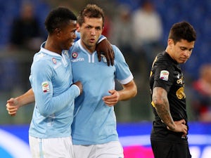 Senad Lulic (C) with his teammate Balde Diao Keita of SS Lazio celebrates after scoring the second team's goal against Hellas Verona on May 5, 2014