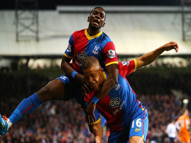 Dwight Gayle #16 (R) of Crystal Palace celebrates with teammate Yannick Bolasie after scoring his team's third goal to level the scores at 3-3 against Liverpool on May 5, 2014