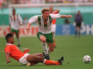 Former Netherlands midfielder Frank Rijkaard slide tackles Andy Townsend on July 04, 1994.