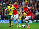 Jonathan Howson of Norwich City closes down Kieran Gibbs of Arsenal during the Barclays Premier League match between Norwich City and Arsenal at Carrow Road on May 11, 2014