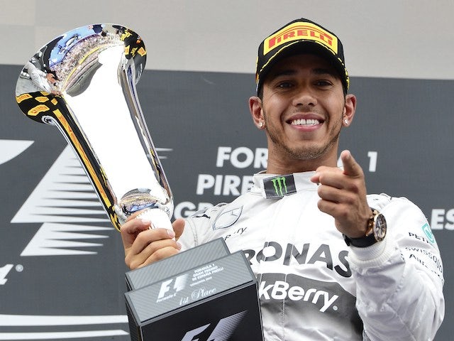 Mercedes-AMG's British driver Lewis Hamilton celebrates on the podium after the Spanish Formula One Grand Prix at the Circuit de Catalunya, in Montmelo on the outskirts of Barcelona on May 11, 2014