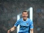 Manchester City's Bosnian striker Edin Dzeko celebrates scoring the opening goal during the English Premier League football match between Manchester City and Aston Villa at the Etihad Stadium in Manchester, Northwest England, on May 7, 2014
