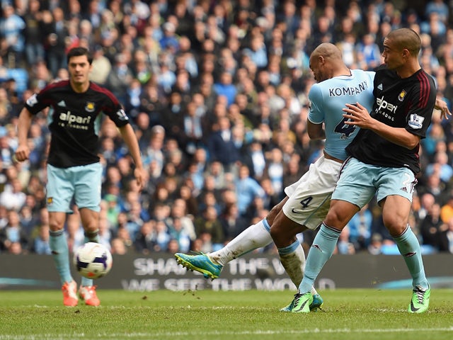 Vincent Kompany of Manchester City scores the second goal during the Barclays Premier League match between Manchester City and West Ham United at the Etihad Stadium on May 11, 2014
