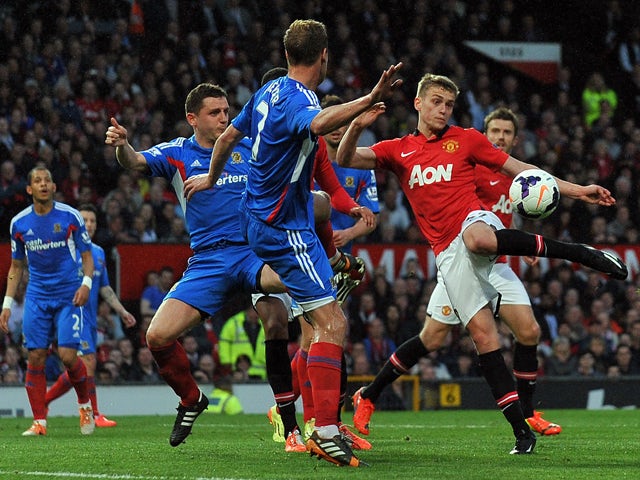 Manchester United's English striker James Wilson shoots to score the opening goal of the English Premier League football match between Manchester United and Hull City at Old Trafford in Manchester, northwest England on May 6, 2014