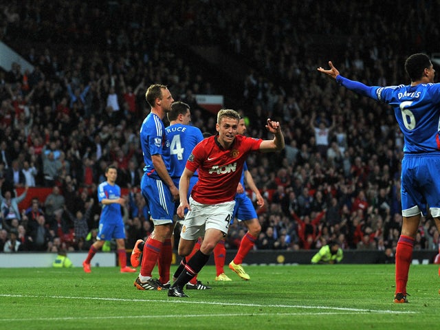 Manchester United's English striker James Wilson celebrates scoring the opening goal of the English Premier League football match between Manchester United and Hull City at Old Trafford in Manchester, northwest England on May 6, 2014