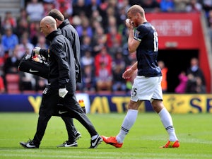 Manchester United's Serbian defender Nemanja Vidic walks off to get treated for a bloody nose during during the English Premier League football match between Southampton and Manchester United at St Mary's stadium in in Southampton on May 11, 2014