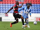 Wigan's Marc-Antoine Fortune and QPR's Nedum Onuoha in action during the Championship play-off first leg match on May 9, 2014