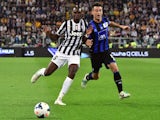Juventus' French midfielder Paul Labile Pogba (L) fights for the ball with Atalanta's defender Giampaolo Bellini during their Serie A match Juventus vs Atalanta, on May 05, 2014