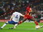 Ghana's Sulley Muntari takes on England midfielder Gareth Barry on March 29, 2011.
