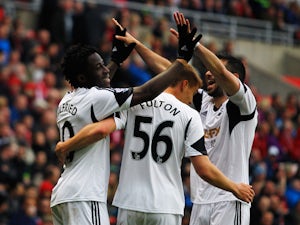 Wilfried Bony of Swansea City celebrates with Jay Fulton and Jordi Amat as he scores their third goal during the Barclays Premier League match between Sunderland and Swansea City at Stadium of Light on May 11, 2014