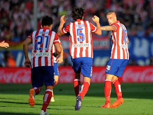 Atletico Madrid's Toby Alderweireld celebrates after scoring his team's first goal against Malaga during the La Liga match on May 11, 2014
