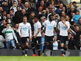 Emmanuel Adebayor of Tottenham Hotspur celebrates with team mates after scoring during the Barclays Premier League match between Tottenham Hotspur and Aston Villa at White Hart Lane on May 11, 2014
